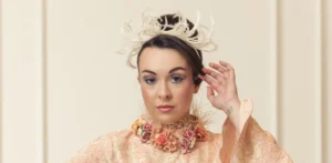 A bride wearing a feather hairpiece.